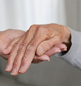 caring elderly hands being held